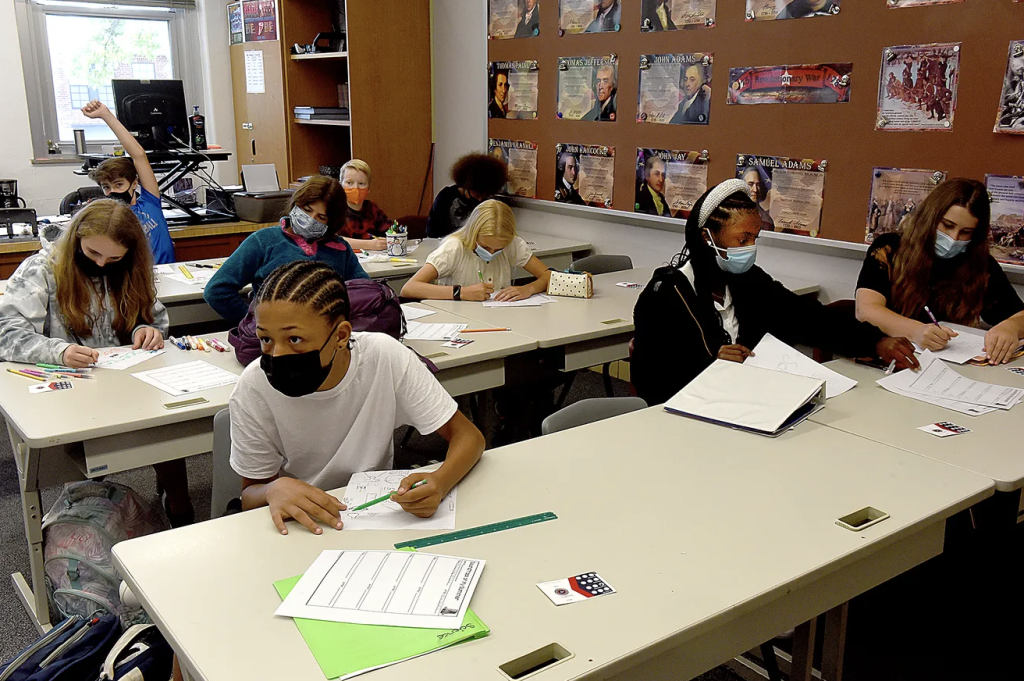 Students sit in a classroom